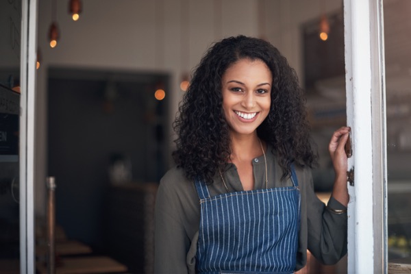 Young adult smiling outside of her job